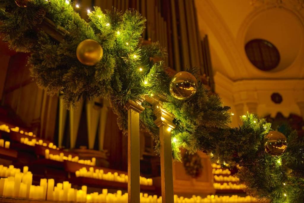 A staircase decorated for a Christmas Candlelight concert.