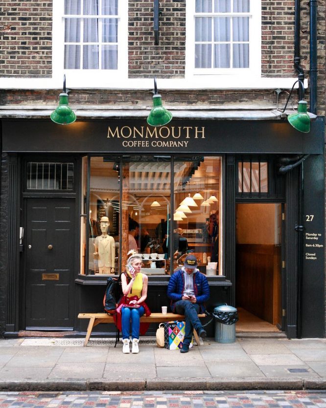People sitting outside the Monmouth Coffee Company in London, England