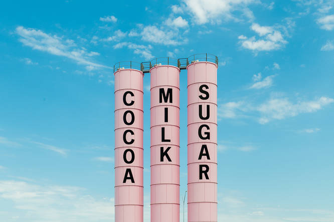 three pastel pink towers saying 'cocoa','milk','sugar' set against a blue sky