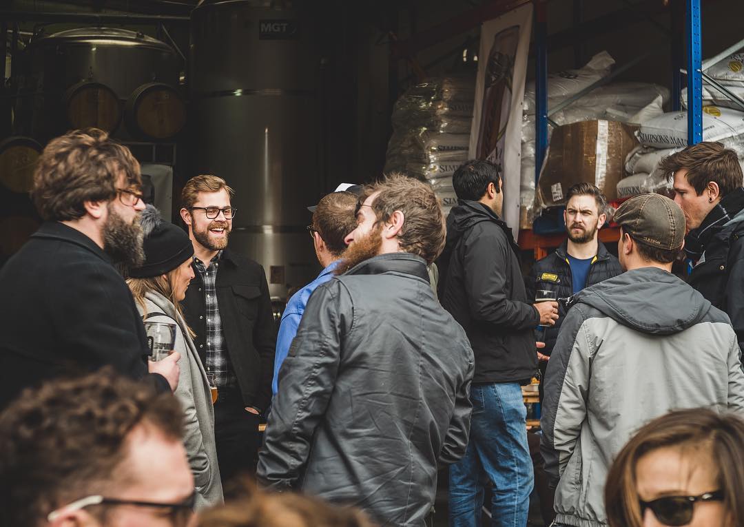 A group of friends milling around outside FourPure Brewery – one of the best things to do in Bermondsey.