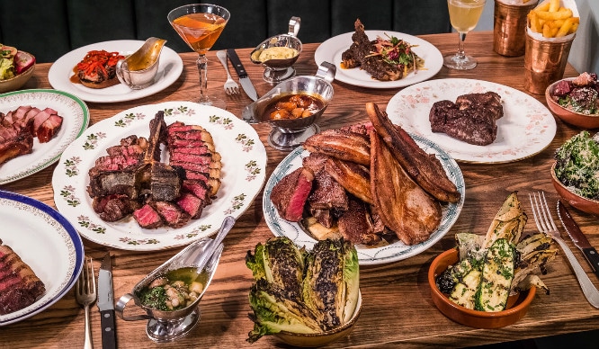 A spread of succulent steak chops, sides and drinks at Blacklock in Soho
