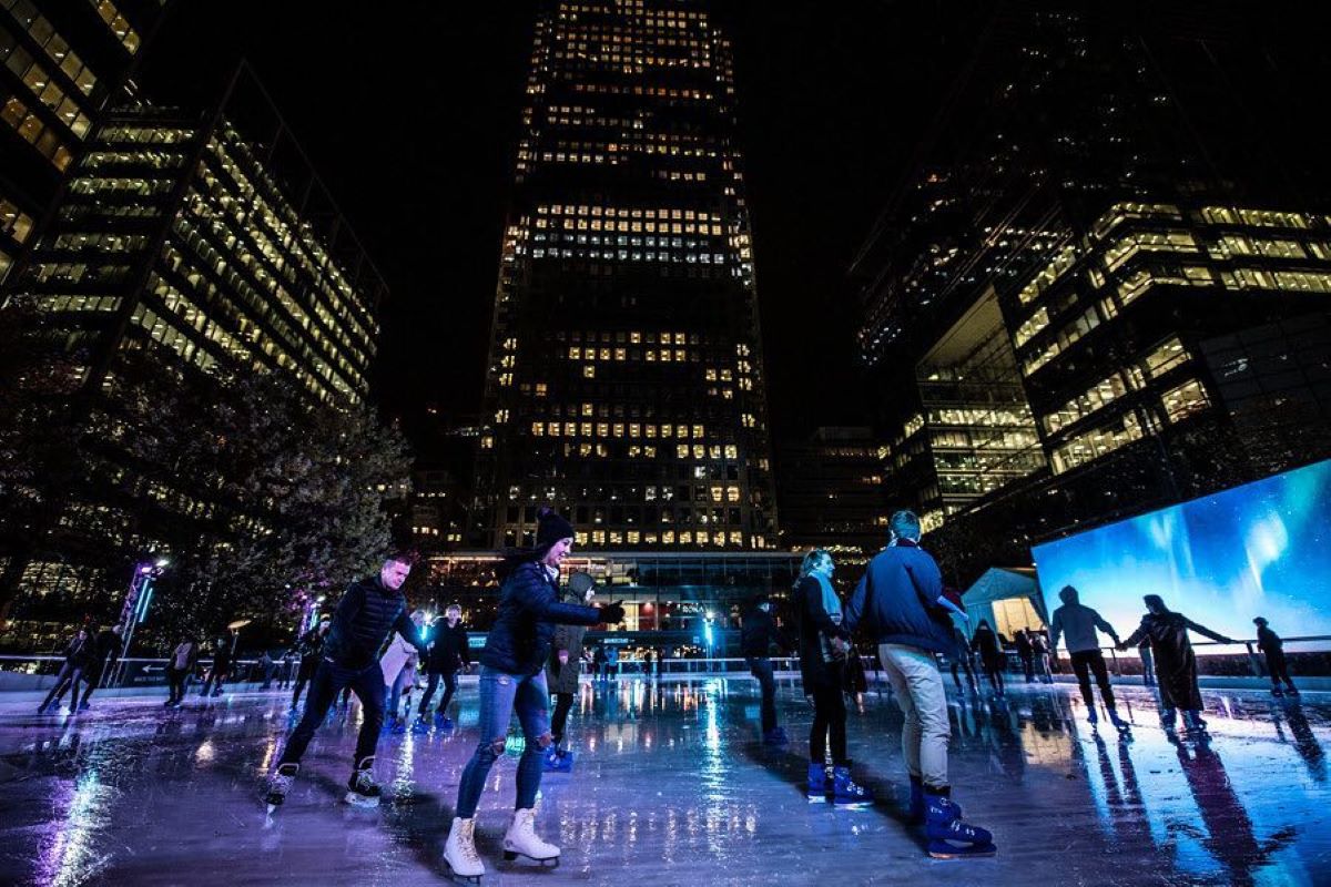 People ice skating at night