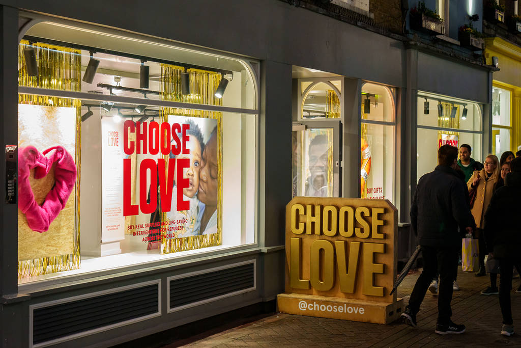 the window and a sign for the choose love store in carnaby