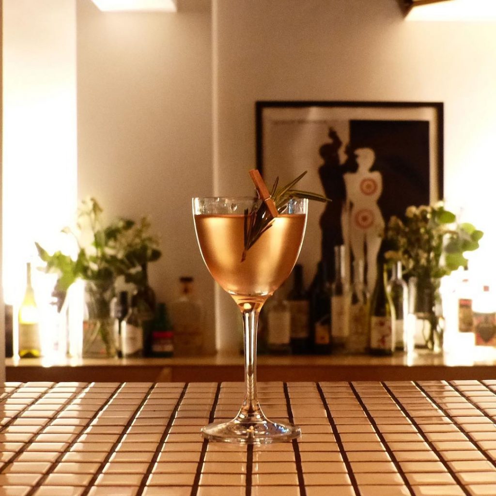 A golden-hued cocktail served at the Behind The Wall cocktail bar in London