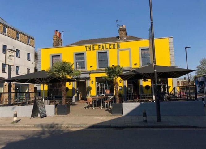 The exterior of The Falcon and accompanying beer garden in Clapham North
