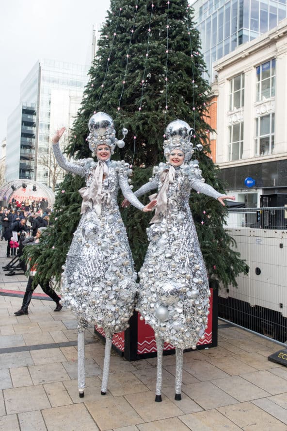 Two women posing for a photograph dressed as sparkling deer at Hammersmith Christmas Market