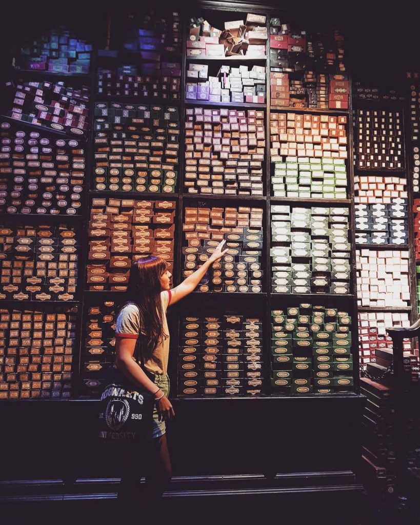A woman looking at a variety of books at the Harry Potter Studio Tour