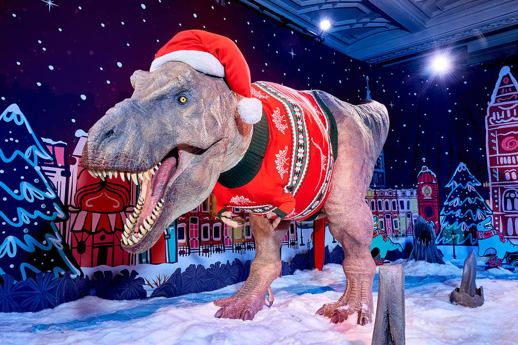the Natural History Museum's T-rex with Natural History Museum 2023 Christmas jumper and hat
