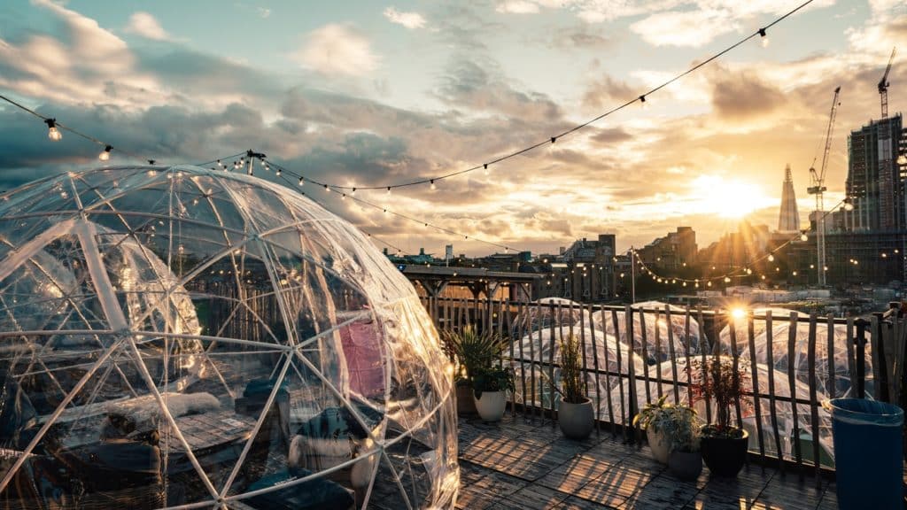igloos spread across two levels with the sunset in the background casting a lovely light over everything