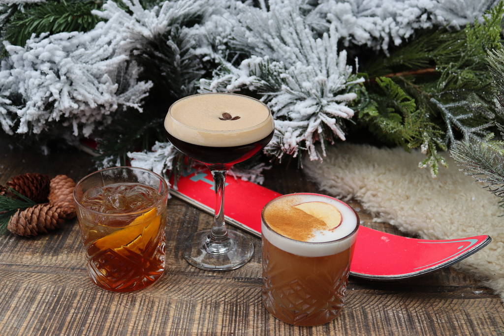 three cocktails of various sizes presented in front of a ski