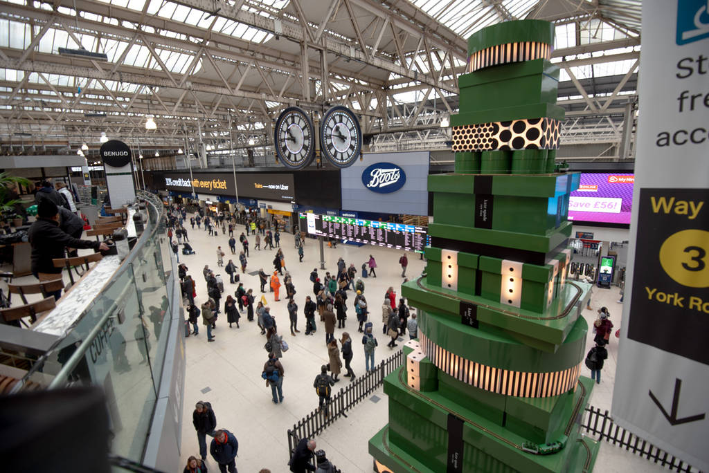 a christmas sculptural installation at waterloo, comprising multiple branded gift boxes making up a 'christmas tree'