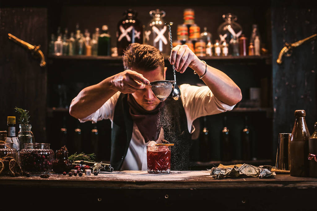 a bartender making a drink at cocktail experience Moonshine Saloon