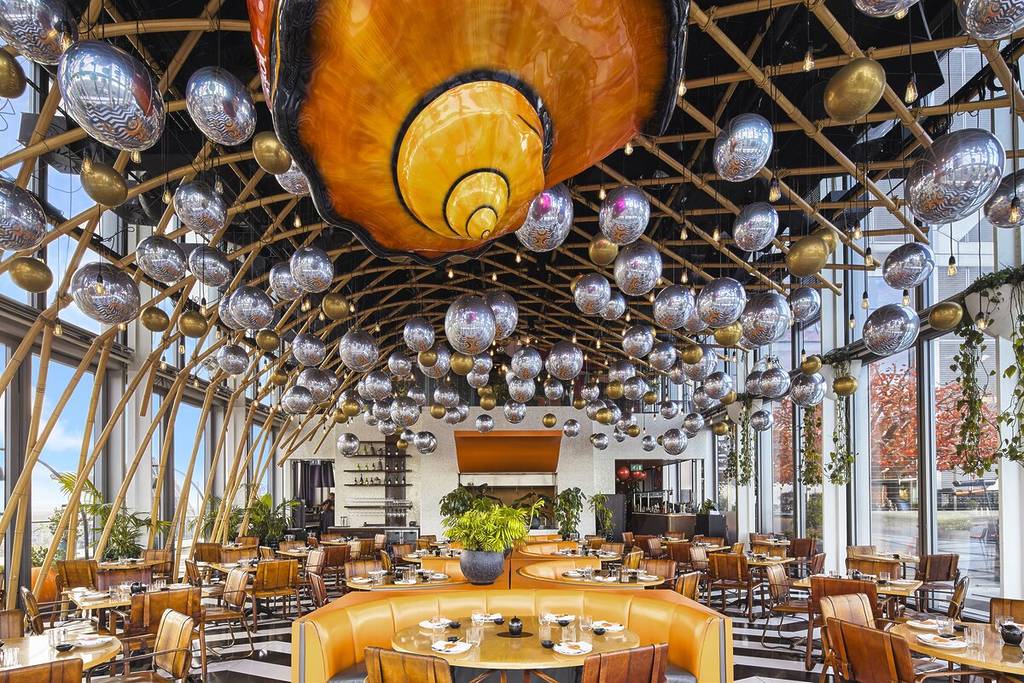 the interior of SUSHISAMBA with metallic balloon decorations hung from the ceiling