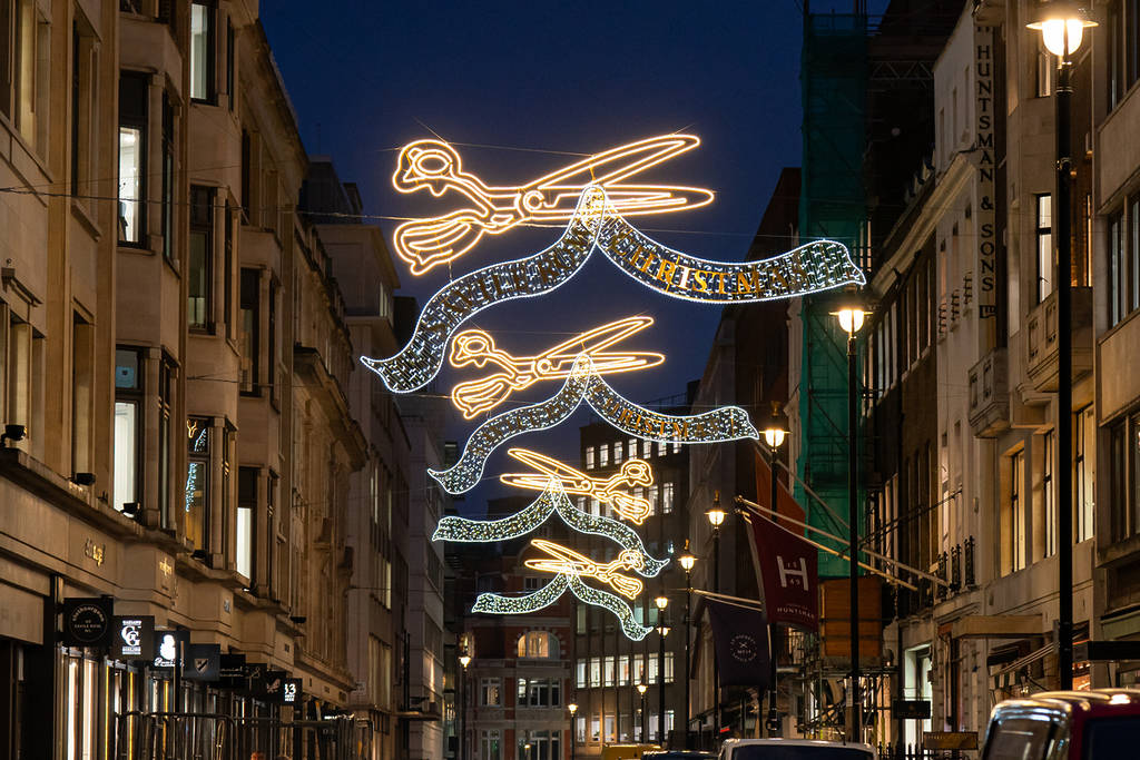 a christmas lights display of golden shears above savile row