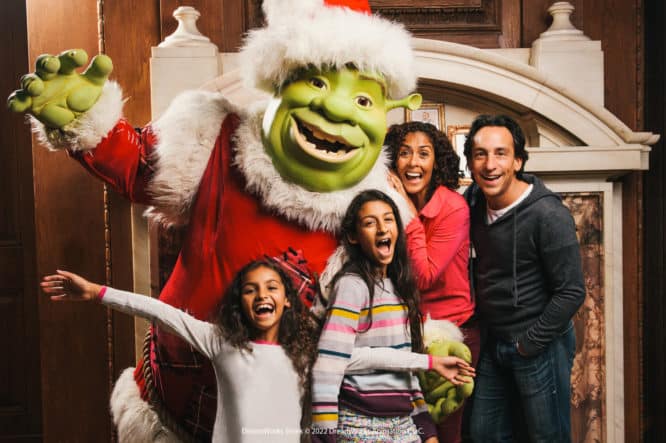 A picture of Shrek with a family at Shrek's Immersive Adventure, one of the best Santa's grottos in London