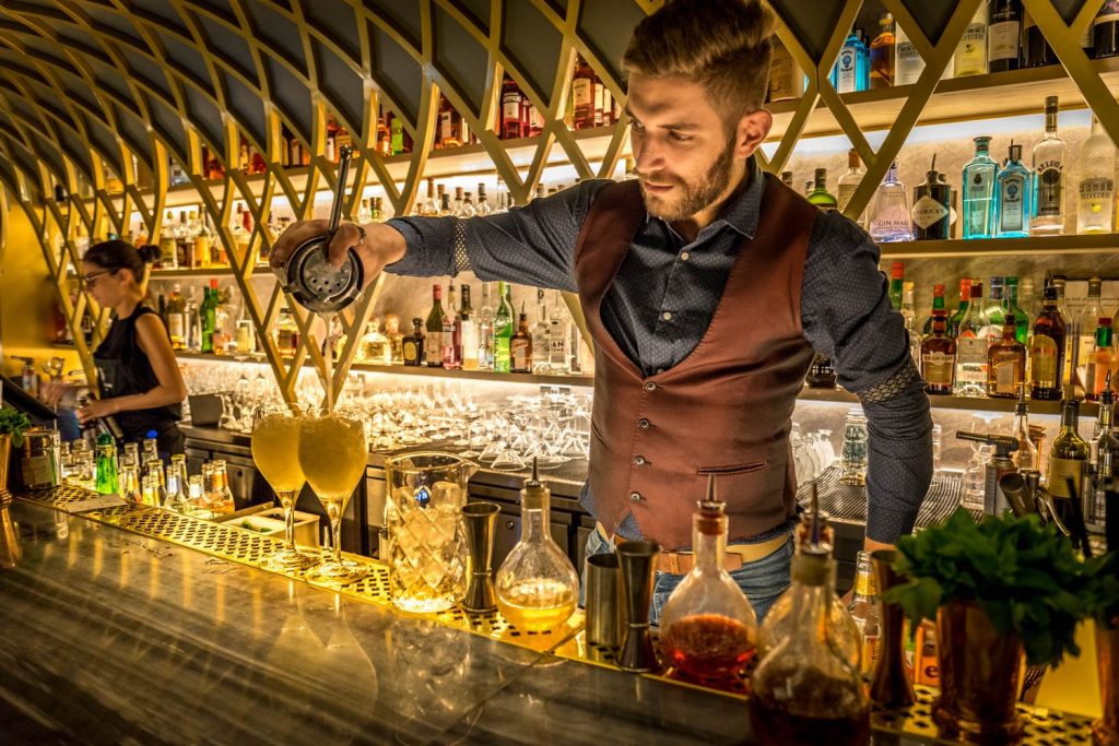 A barman mixing a drink at one of the best cocktail bars in London