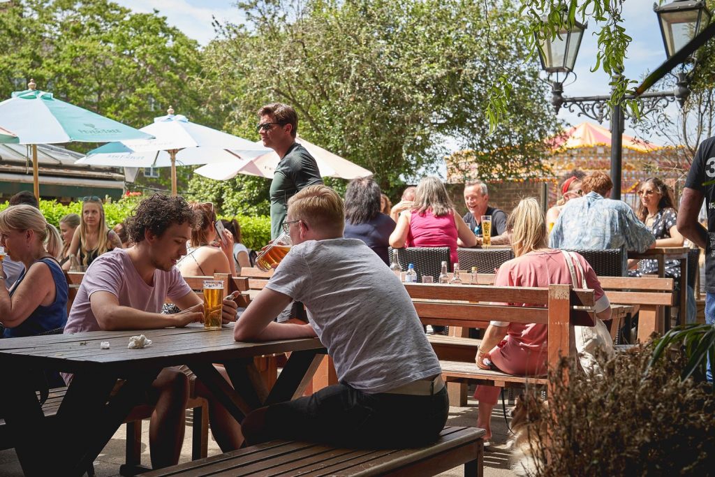 People soaking up the sun in one of the best London beer gardens