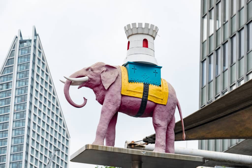 A statue of the Elephant and Castle surrounded by gleaming skyscrapers in London