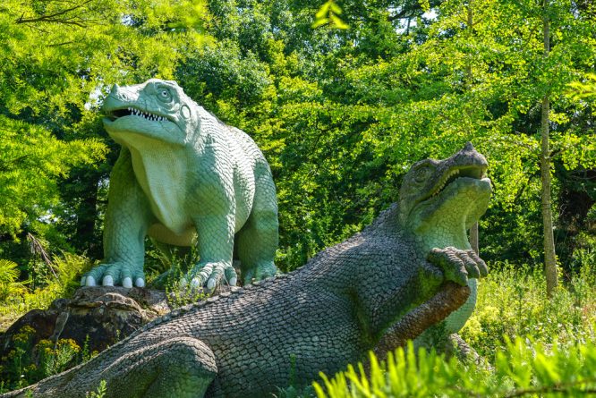 Two of the iconic dinosaurs on display at Crystal Palace Park, one of the best places for a dog walk in London
