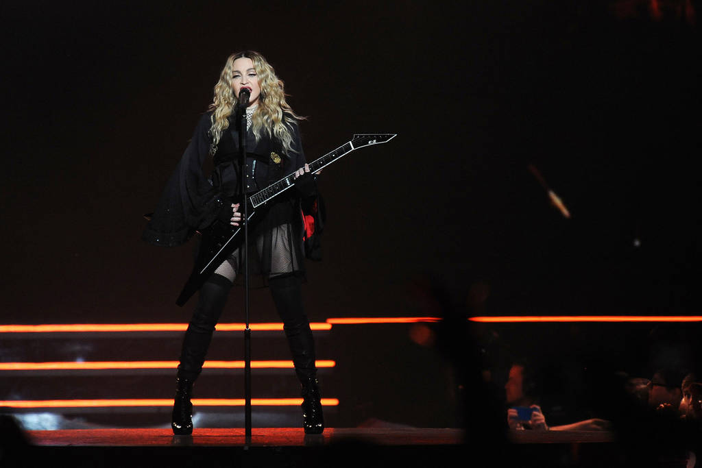 The legendary singer and entertainer Madonna performing to. crowd at a concert