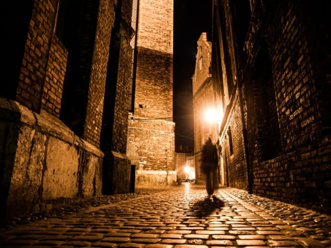 An ominous picture of a shadowy man walking down an alleyway on one of the best ghost tours in London