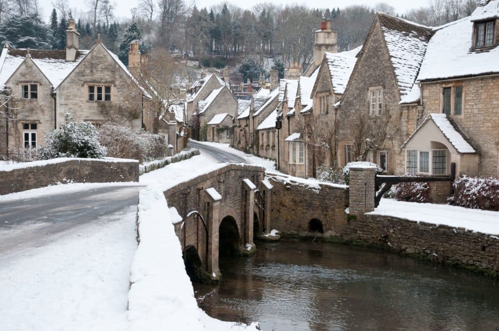 Castle Combe village in England covered in snow, one of the best winter staycations in the UK