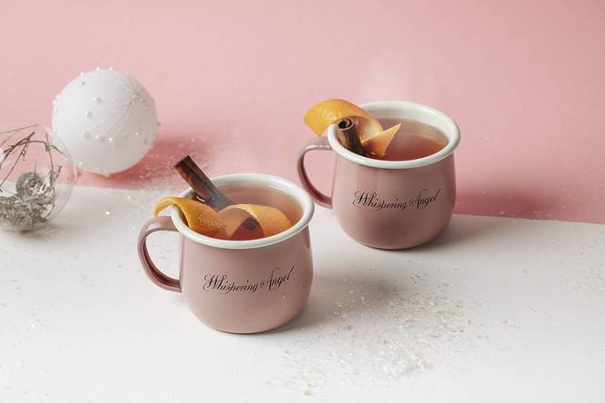 Two cups of mulled wine in pink Whispering Angel mugs