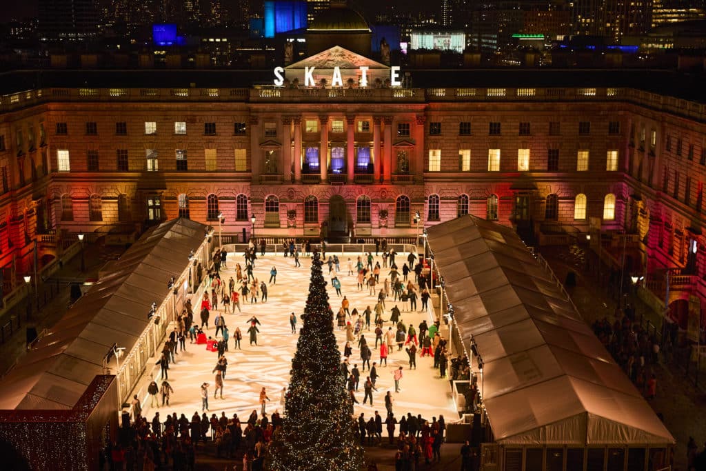 An aerial view of the Somerset House ice rink, filled with skaters.
