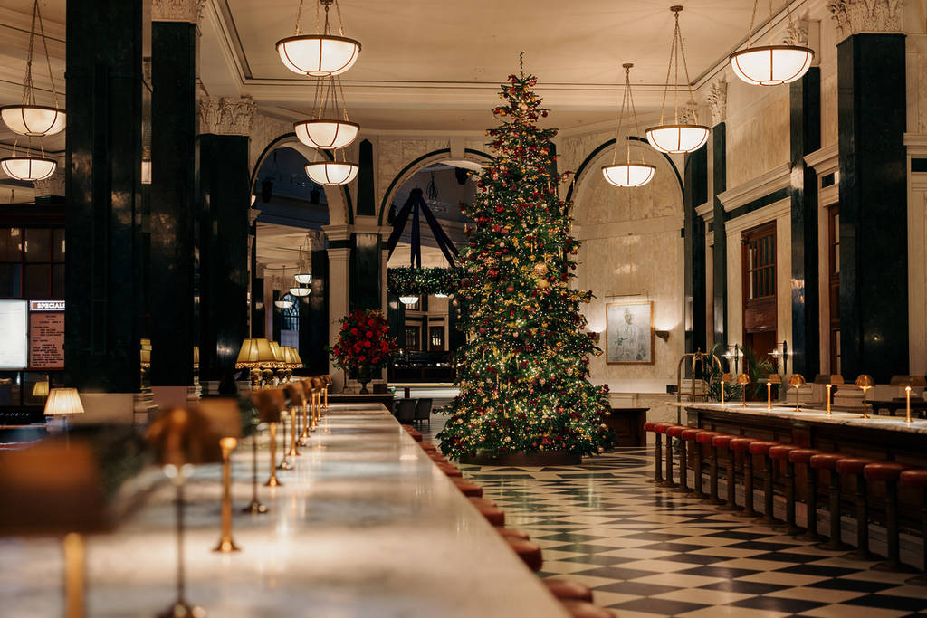 an classic christmas tree with old world charm in the restaurant lobby at the ned