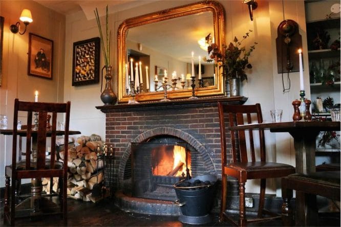 The interior of The Flask pub in Highgate with a roaring fire