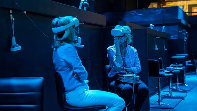 Two women sit with VR goggles on at the Van Gogh Immersive Experience in Spitalfields 