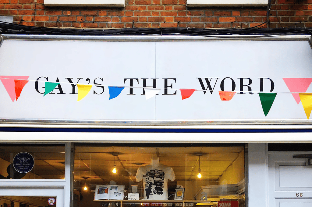 the exterior sign for the gay's the word bookshop, with colourful bunting strung across it